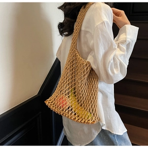Detail of hand-woven mesh tote bag with reinforced handles for heavy groceries