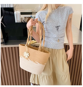 Close-up of a woven tote bag with a floral charm on a cafe background scene