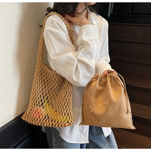 Detail view of woven mesh tote with a removable brown drawstring canvas inner pouch