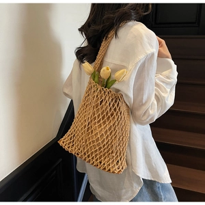 Detail of hand-woven mesh shoulder bag featuring a stylish diamond-hollow crochet design