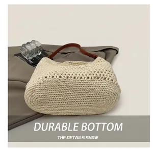 Detail showing the reinforced wear-resistant base of this hand-woven straw bucket bag