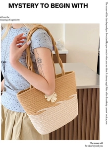 Detail of woven straw tote bag featuring contrast colors and stylish white bow knot