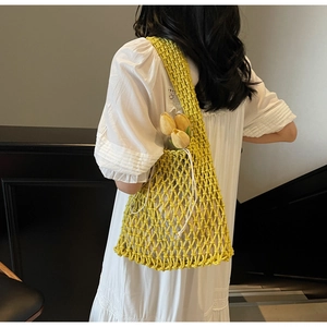 Detail of yellow woven mesh bucket bag with a white drawstring inner pouch for women