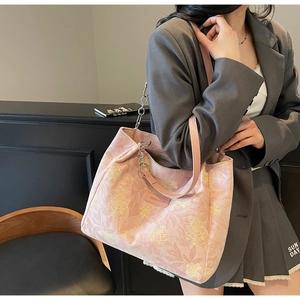 Detail of pink floral tote bag with Sakura Diary leather tag and metal chain strap
