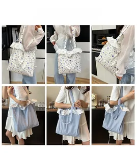 Detail view of floral and striped canvas tote bags featuring delicate white lace trim edges