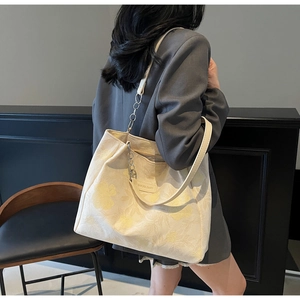 Detail of floral printed tote bag with metal chain strap and Sakura Diary label