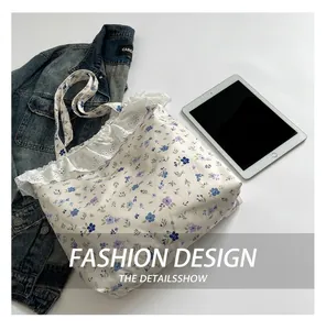 Detailed view of floral canvas tote bag with delicate white lace trim and floral patterns