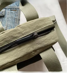 Detailansicht des glatten Metallreißverschlusses an einer Nylon-Canvas-Umhängetasche