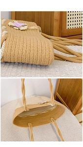 Detail of woven straw tote bag featuring purple flower accents and inner compartment
