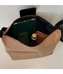 Detailed view of the spacious nylon hobo bag interior with compartments for essentials