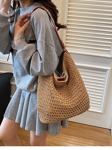 Handwoven straw shoulder bag with leather straps for beach holidays and casual daily use
