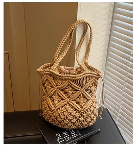 Detail of hand-woven cotton shoulder bag with diamond mesh pattern and inner drawstring bag
