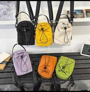 Multiple colorful nylon drawstring crossbody bags in a variety of trendy sports styles