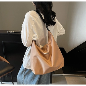 Detail of camel large capacity hobo bag with adjustable strap and metallic logo plate