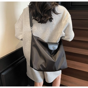 Rear view of a black Oxford tote bag showing its large capacity and stylish slouchy fit