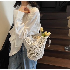 Close-up of beige macramé shoulder bag with flower crochet pattern and inner lining