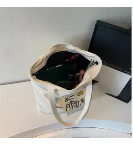 Spacious interior of white canvas tote bag showing large capacity for daily essentials