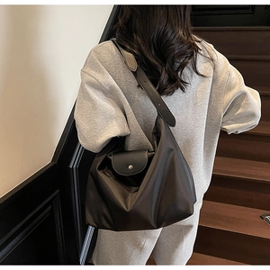Lifestyle view of large Oxford fabric tote bag worn as a crossbody on a shoulder