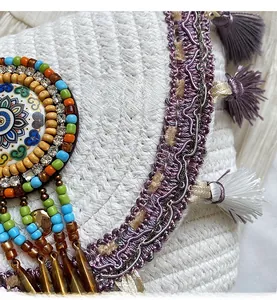 Macro shot of ethnic woven bag featuring colorful beads, fringes, and mandala pattern