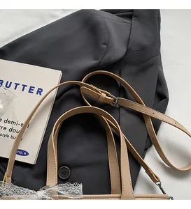 Détail d'un sac tressé abricot clair avec dentelle blanche et bandoulière réglable