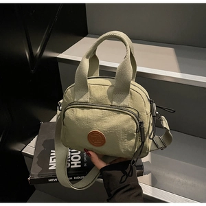 Hellgrüne Nylon Umhängetasche mit Reißverschlussfach und Lederlogo auf Modemagazin