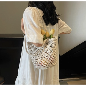 Close-up of white handmade crochet tote bag featuring intricate diamond openwork patterns