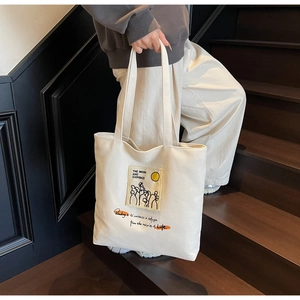 Detail of off-white canvas tote bag featuring literary text and artistic sketch print