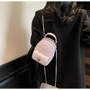 Detail of pink quilted leather mini backpack with shimmering rhinestones and chain strap