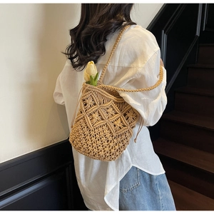 Detail of hand-woven cotton shoulder bag with hollow diamond pattern and drawstring closure