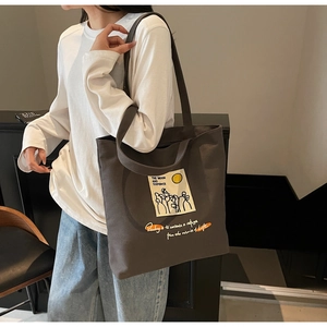 Detailed view of dark brown canvas tote bag with literary art print and long shoulder strap