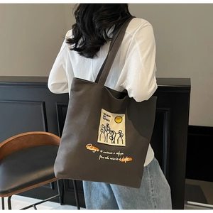 Detailed view of canvas tote bag featuring Moon and Sixpence quote and illustration