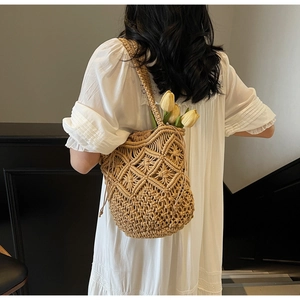 Detail of the woven hollow diamond pattern on this beige cotton rope shoulder beach bag