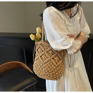 Detail of hand-woven cotton shoulder bag featuring hollow geometric textures and drawstring