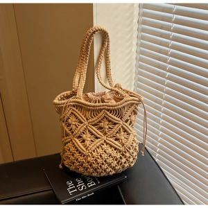 Detail of bohemian hand-woven tote bag with drawstring lining and textured cotton cord