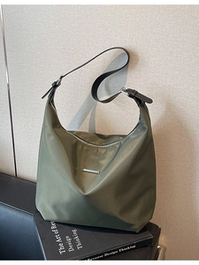 Minimalist olive green nylon crescent crossbody bag with adjustable black leather strap