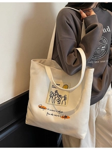 Artistic cream canvas tote bag with abstract print and literary quote for daily commute