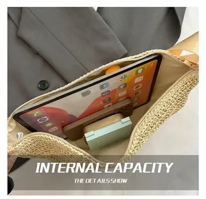 Interior view showing the large capacity of the beige straw woven crossbody bag