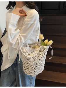 Handmade white woven cotton rope bucket bag with hollow geometric patterns and drawstring liner