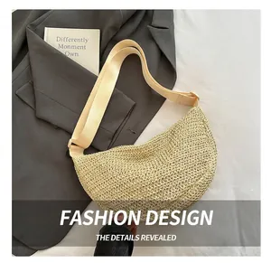 Detailed close-up of beige woven crescent bag with adjustable strap on grey blazer