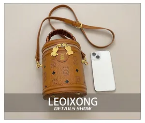 Detail of bear pattern leather bucket bag with silk scarf handle and metal zipper