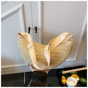 Detail of hand-woven straw crossbody bag with adjustable wide canvas shoulder strap