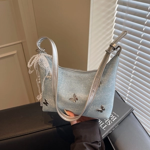 Light blue denim shoulder bag with silver butterfly charms and pearl lace pendant accents