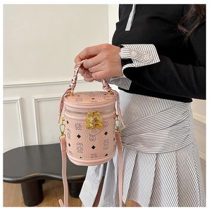 Pink bucket bag with cute bear prints, silk scarf handle, and golden metal zip detail