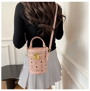 Detail of pink cylinder bucket bag with bear print and silk scarf wrapped handle