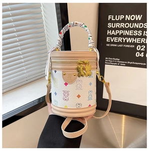 Detailed view of white teddy bear print bucket bag with scarf-wrapped handle and gold zippers