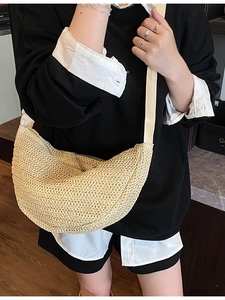Minimalist straw crescent crossbody bag with woven texture and wide shoulder strap