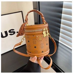 Detail of the brown bear pattern bucket bag with silk scarf handle and dual metal zippers
