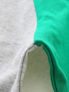 Close-up of gray and neon green stitched seams on a high-quality knit cotton kids T-shirt