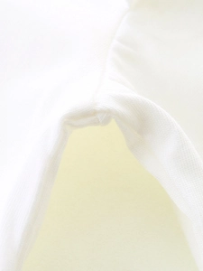 Close-up of fine sewing craft and soft knit fabric on girls white Halloween t-shirt