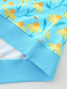 Blue girls' sweatshirt with daisy and bee prints featuring elastic ribbed hem detail